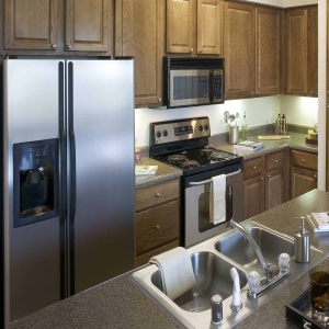 kitchen area of villas of spring creek with stainless refrigerator, stove and microwave