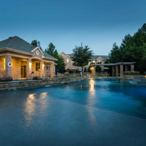 Second Pool at Villas of Spring Creek at evening time with buildings in the background